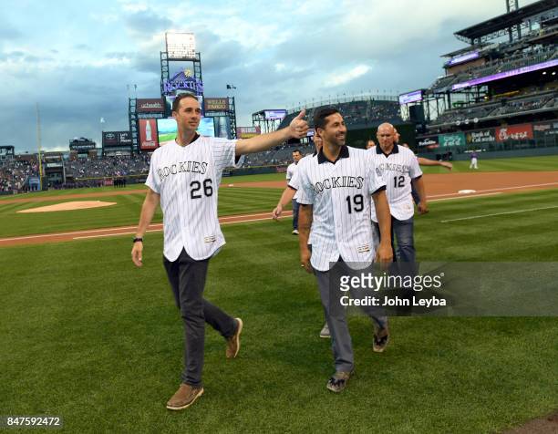 Former Colorado Rockies Jeff Francis gives a thumbs up to the fans as he walks off the field with Ryan Spilborghs prior to the game against the San...