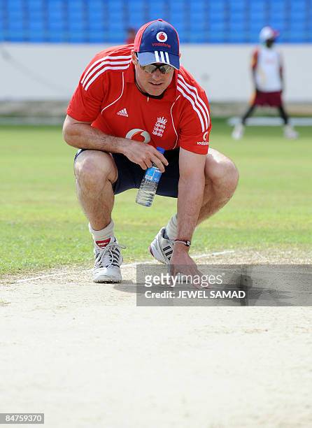 England's cricket captain Andrew Strauss checks the pitch during a practice session at the Sir Vivian Richards Cricket Ground ahead of their second...