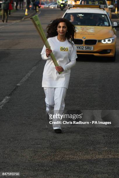 Jasmine Vanmali carries the torch from the National Space Centre during the dress rehearsal for the London 2012 Olympic Torch Relay.