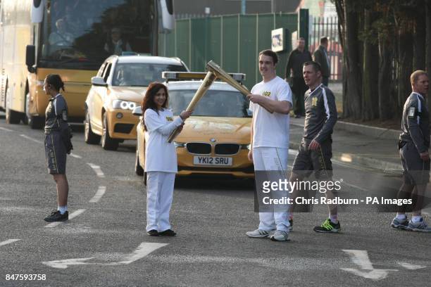 Jasmine Vanmali and Samuel Rowbotham carry the torch from the National Space Centre during the dress rehearsal for the London 2012 Olympic Torch...