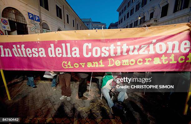 Banner for the "Defence of the constitution" is unfolded before protesters at the moment that former Italian President Oscar Luigi Scalfaro speaks to...