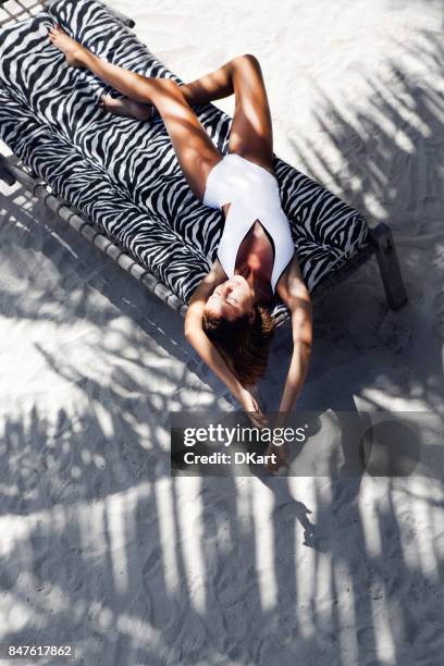 tanned girl in a swimsuit - beach glamour stock pictures, royalty-free photos & images