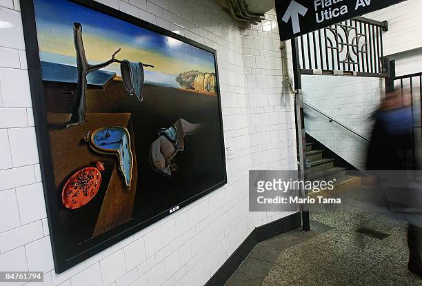 Rider walks past a reproduction of a Salvador Dali painting in the Atlantic Avenue subway station February 12, 2009 in the Brooklyn borough of New...
