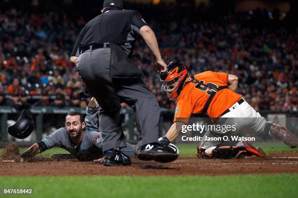 Daniel Descalso of the Arizona Diamondbacks is tagged out at home plate by Nick Hundley of the San Francisco Giants in front of umpire Doug Eddings...