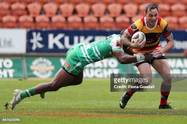 Zac Guildford of Waikato is tackled by William Ambaka of Manawatu during the round five Mitre 10 Cup match between Waikato and Manawatu at FMG...