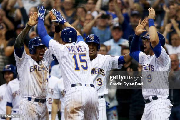 Eric Sogard, Neil Walker, Orlando Arcia, and Manny Pina of the Milwaukee Brewers celebrate after Walker hit a grand slam in the eighth inning against...