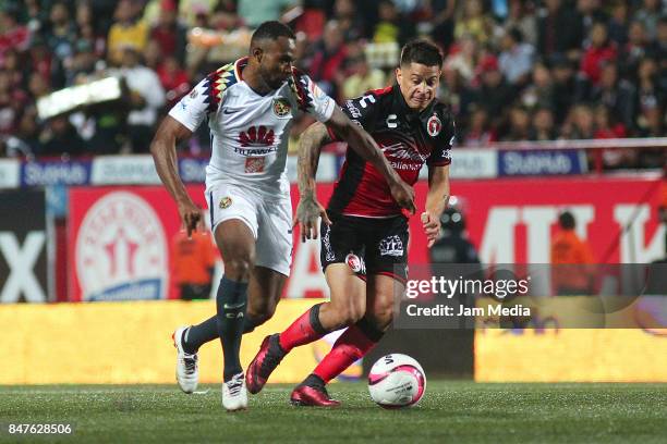 William Da Silva of América and Juan Iturbe of Tijuana fight for the ball during the 9th round match between Tijuana and America as part of the...