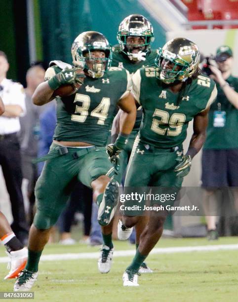 Linebacker Keirston Johnson of the South Florida Bulls and teammate linebacker Devon Jones-Stewart celebrate after game-ending interception against...