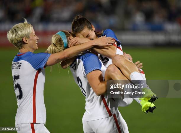 United States midfielder Megan Rapinoe celebrates with United States defender Julie Ertz who picked up United States defender Kelly O'Hara in...