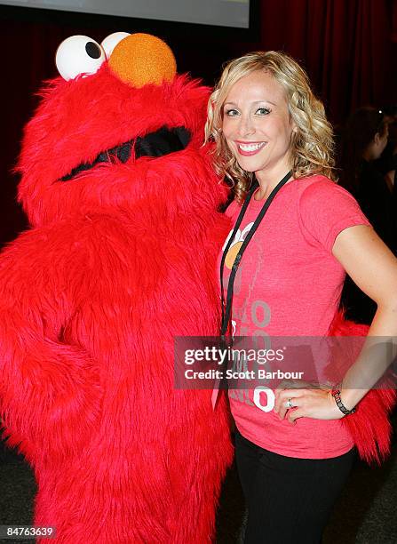 Teresa Livingstone poses for a photograph with Elmo, the Muppet character from television's Sesame Street as they help raise funds for the Victorian...