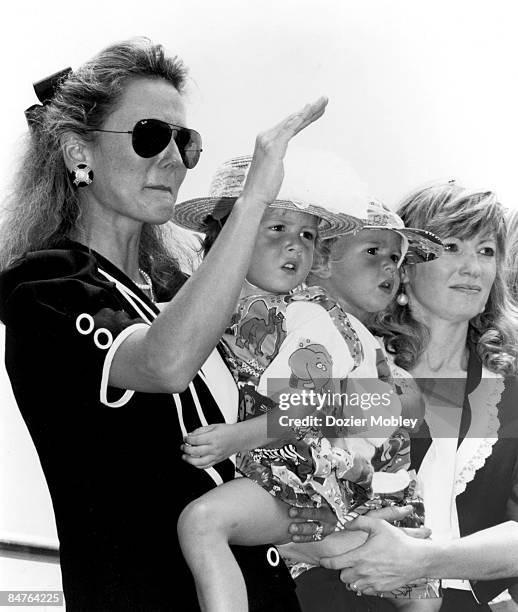 Liz Allison, wife of Davey Allison, waves a salute to her departed husband at the Memorial Service on July 26, 1993 in Talladega, Alabama. Liz is...