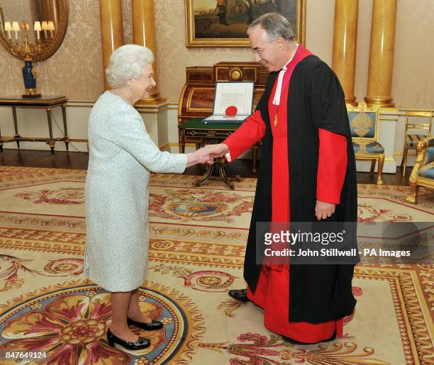Queen Elizabeth II shakes hands with the Dean of Westminster Abbey Dr John Hall, before she presents a historic Charter that sets out how the Abbey...