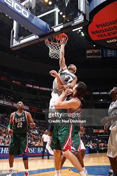 Caron Butler of the Washington Wizards goes for a dunk against Andrew Bogut of the Milwaukee Bucks during the game at the Verizon Center on January...