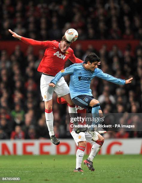 Ajax's Aras Ozbiliz and Manchester United's Phil Jones battle for the ball