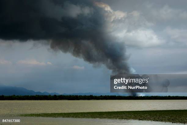 Smoke billows above what is believed to be a burning village in Myanmar's Rakhine state. According to United Nations more than 300 thousand Rohingya...