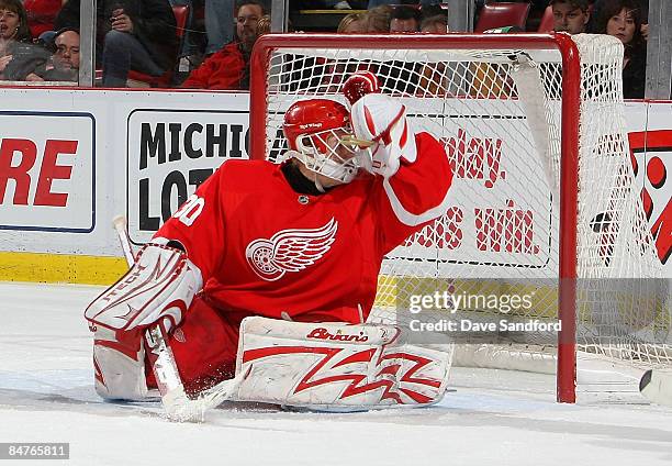 Chris Osgood of the Detroit Red Wings is beat on this shot by Brent Burns of the Minnesota Wild during their NHL game at Joe Louis Arena February 12,...