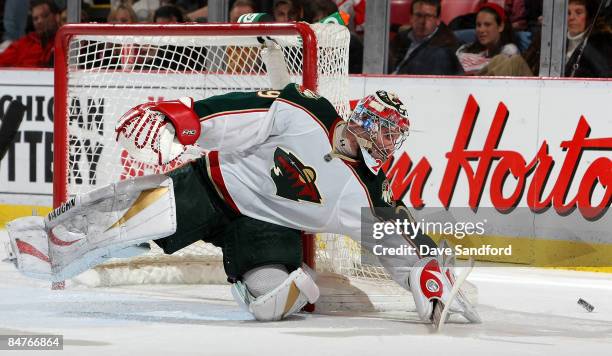 Josh Harding of the Minnesota Wild turns aside a shot by the Detroit Red Wings during their NHL game at Joe Louis Arena February 12, 2009 in Detroit,...