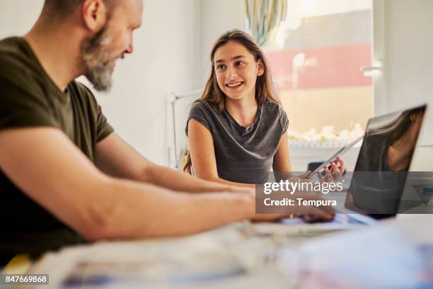 single father helping teenager with her homework. - single father stock pictures, royalty-free photos & images