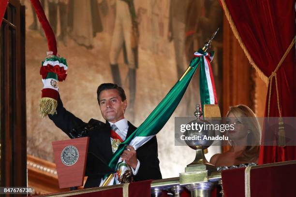 Mexican President Enrique Pena Nieto and his wife, the First Lady Angelica Rivera are seen during the traditional "El Grito" or "The Shout" at the...