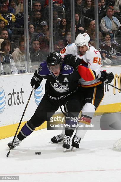Anze Kopitar of the Los Angeles Kings chases after the puck against Adam Pardy of the Calgary Flames on February 12, 2009 at Staples Center in Los...