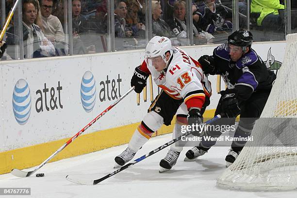 Michael Cammalleri of the Calgary Flames skates with the puck against Peter Harrold of the Los Angeles Kings on February 12, 2009 at Staples Center...