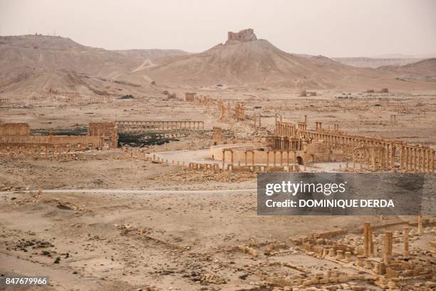 Picture taken from a helicopter during a press tour provided by the Russian Armed Forces on September 15, 2017 shows an aerial view of the ruins of...