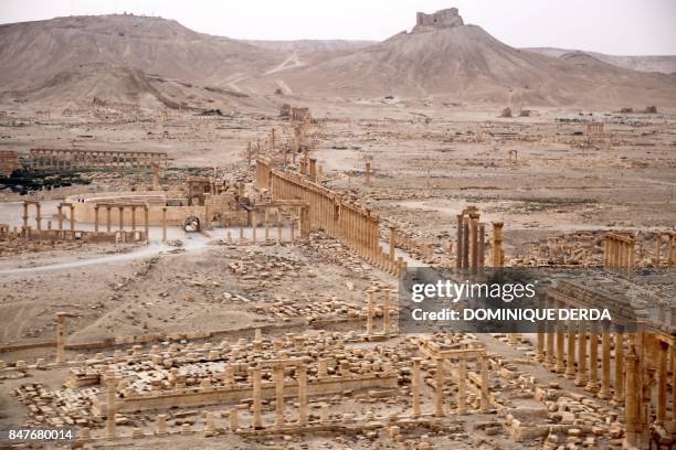 Picture taken from a helicopter during a press tour provided by the Russian Armed Forces on September 15, 2017 shows an aerial view of the ruins of...