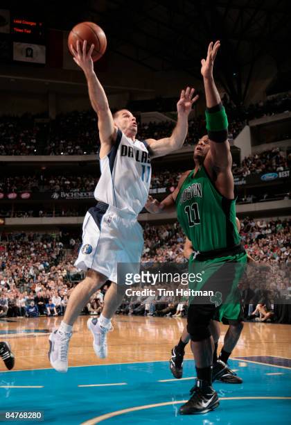 Jose Juan Barea of the Dallas Mavericks goes up for the layup against Glen Davis of the Boston Celtics on February 12, 2009 at the American Airlines...