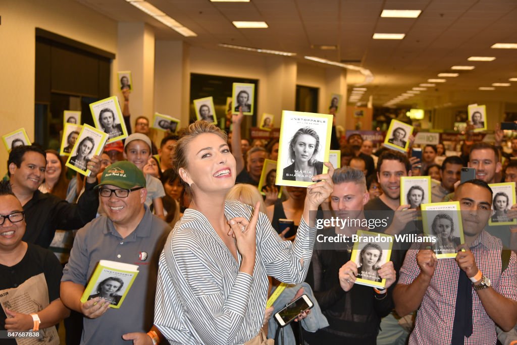 Professional tennis player Maria Sharapova poses with fans during the