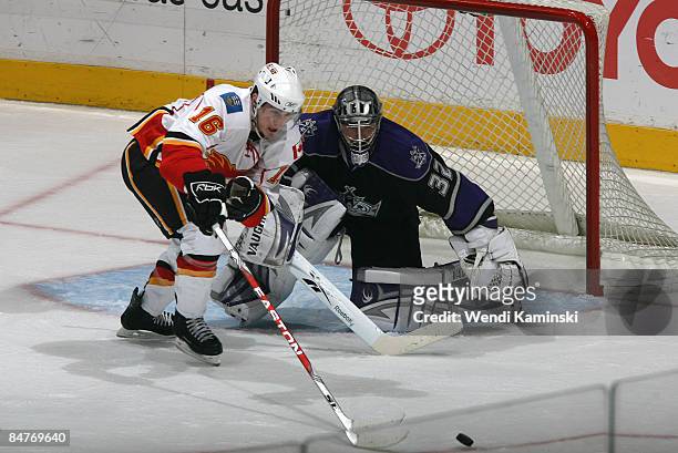 Dustin Boyd of the Calgary Flames reaches for the puck against Jonathan Quick of the Los Angeles Kings on February 12, 2009 at Staples Center in Los...