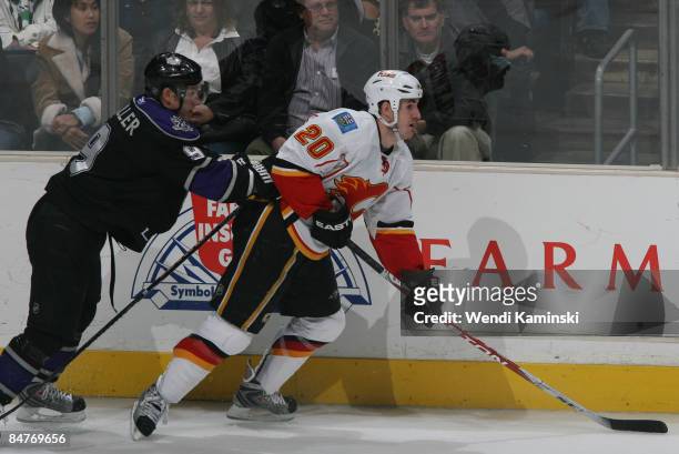 Curtis Glencross of the Calgary Flames skates ahead of Oscar Moller of the Los Angeles Kings on February 12, 2009 at Staples Center in Los Angeles,...