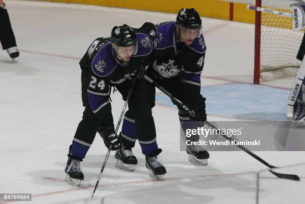 Alexander Frolov and Raitis Ivanans of the Los Angeles Kings await a faceoff during a game against the Calgary Flames on February 12, 2009 at Staples...