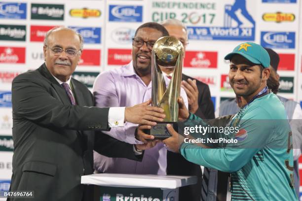 Pakistani cricketers skipper Sarfraz receiving trophy from Chairman Pakistan Cricket board Najam Sethi after winning the Twenty20 International match...