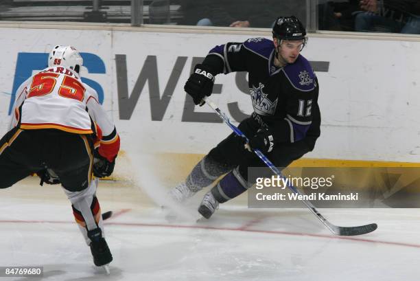 Patrick O'Sullivan of the Los Angeles Kings skates against Adam Pardy of the Calgary Flames on February 12, 2009 at Staples Center in Los Angeles,...