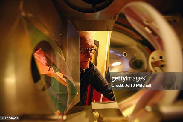 Ian Kerr the projectionist at the Hippodrome cinema in Bo'ness, inspects his projector on February 12, 2009 in Scotland. The Hippodrome, Scotland's...