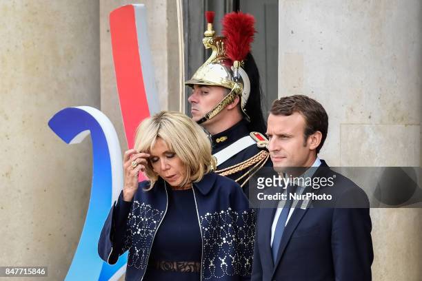 French President Emmanuel Macron and his wife Brigitte Trogneux wait to welcome their guests to celebrate Paris being announced as the host of the...