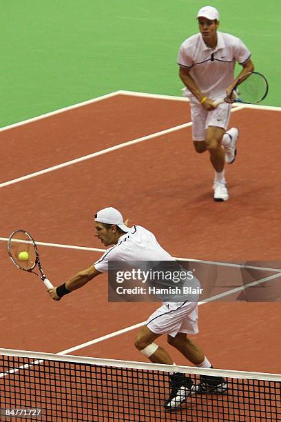 Jurgen Melzer of Austria volleys with partner Tomas Berdych of Czech Republic looking on during their doubles quarterfinal match against Jeff Coetzee...