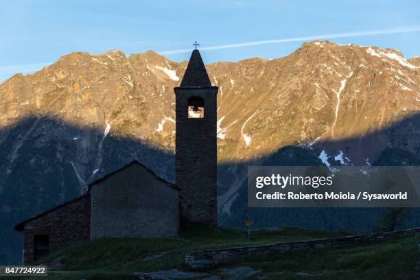 medieval church at sunrise, san romerio alp, switzerland - brusio grisons stock pictures, royalty-free photos & images