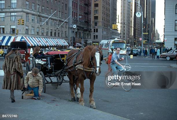 Carriage driver has her shoes shined, New York, April 1978.