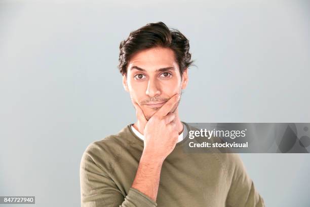 portrait of serious young man - raised eyebrows imagens e fotografias de stock