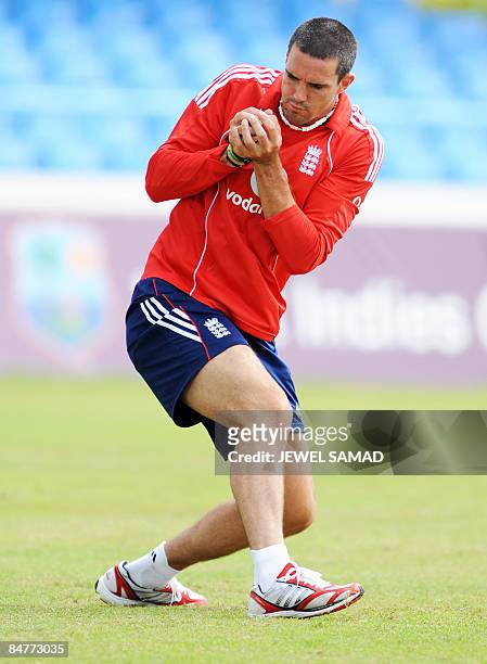England's cricketer Kevin Pietersen grips a catch during a practice session at the Sir Vivian Richards Cricket Ground ahead of their second Test...
