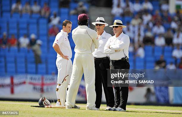 England's cricket team captain Andrew Strauss and his West Indies counterpart Chris Gayle talk to umpires during the first day of the second Test...