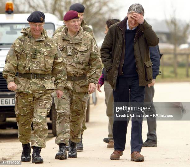 Defence Secretary Philip Hammond and Chief of the Defence Staff General Sir David Richards just after being confronted by a goat during a visit to...