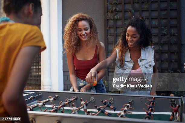 three young women playing foosball at youth hostel - before the 24 stock pictures, royalty-free photos & images