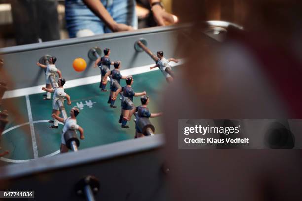 three young women playing foosball at youth hostel - totó - fotografias e filmes do acervo