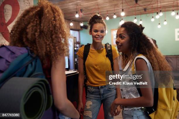 young women signing in to youth hostel - hostel people travel stock pictures, royalty-free photos & images