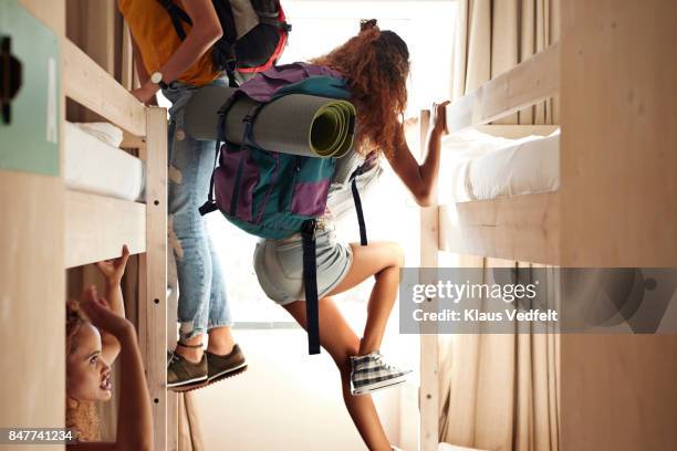 young women arriving to room with bunk beds, at youth hostel - hostel stock pictures, royalty-free photos & images