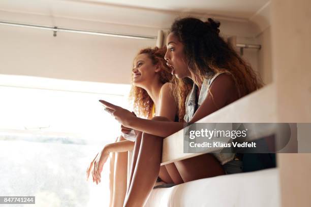 young women sitting in bunk beds and talking and laughing together - summer university day 2 foto e immagini stock