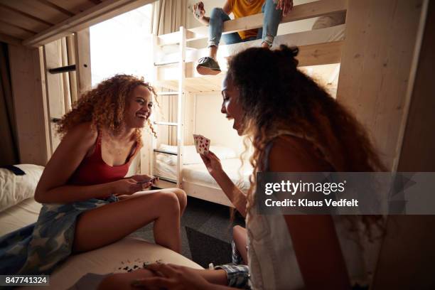 young women playing cards in bunk bed, at youth hostel - bunk beds for 3 stock pictures, royalty-free photos & images