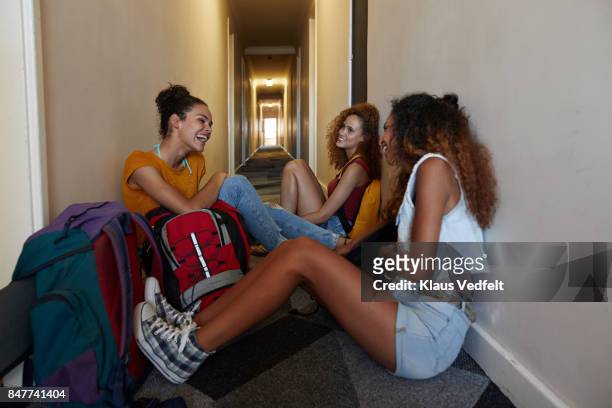 young women with backpacks sitting and waiting on the isle of youth hostel - hostel people travel stock-fotos und bilder